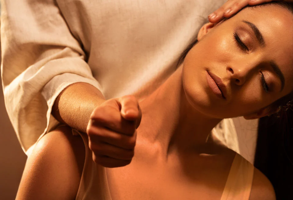 A young lady getting a relaxing neck and shoulder Thai Massage in a spa