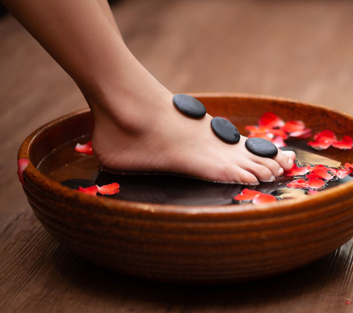 A man getting a strong foot massage with Hot Stone