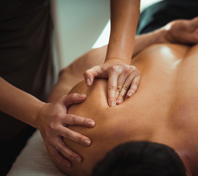 An athletic man getting a strong Sports massage by a highly skilled masseuse in a spa