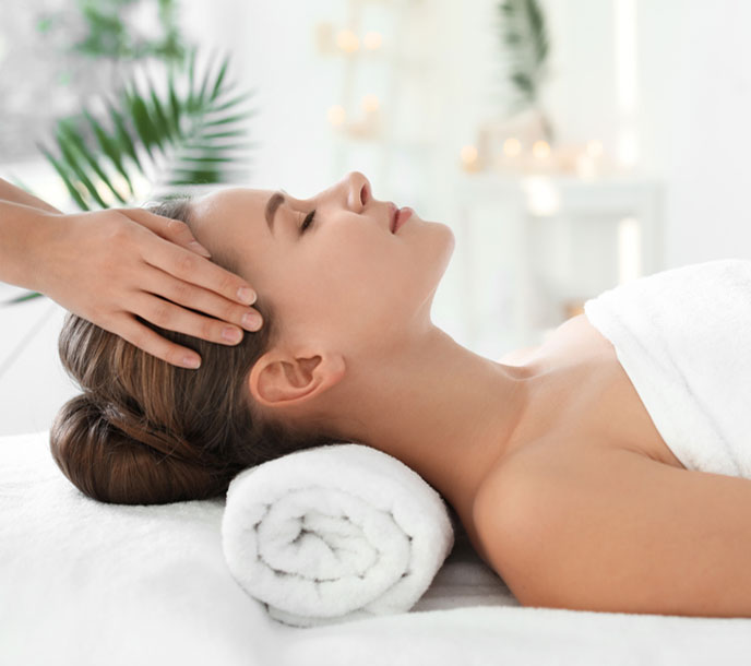 A lady getting a relaxing aromatherapy head massage